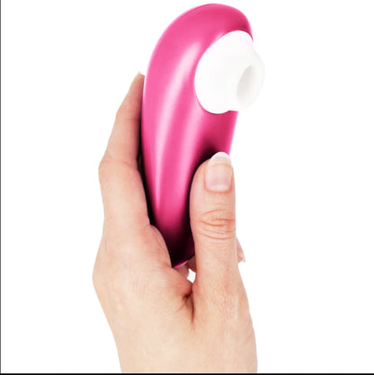 Stimulateur clitoridien sans contact rose à embout blanc en silicone, tenu en main