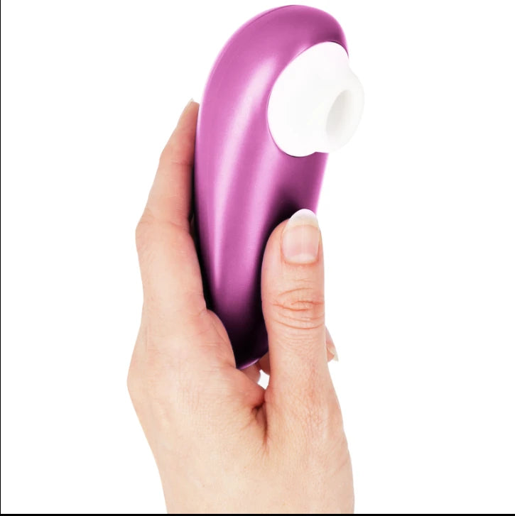Stimulateur clitoridien sans contact violet à embout blanc en silicone, tenu en main